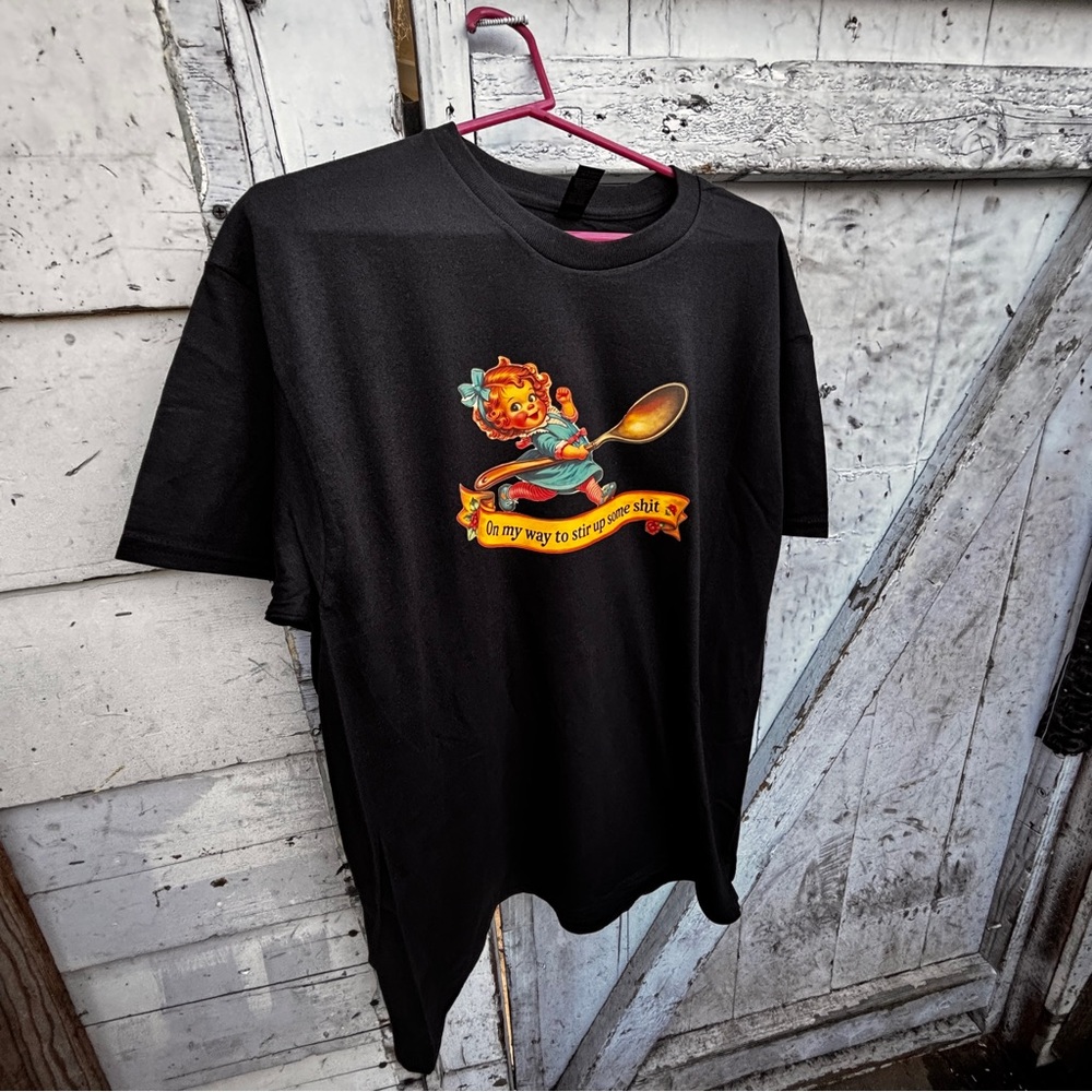 “On my way to stir up some sh*t” on Gildan Black T-Shirt with Colorful Graphic